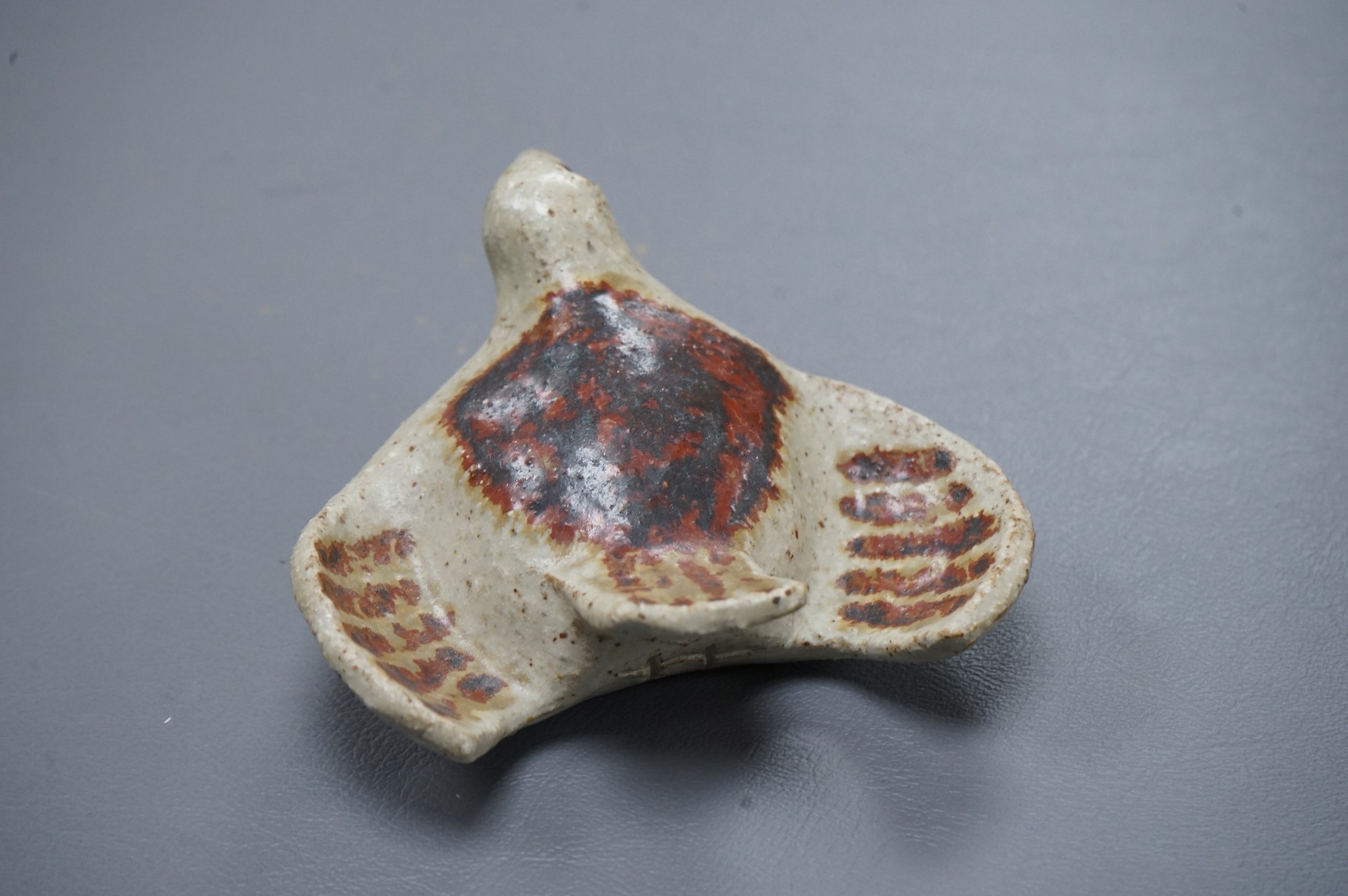 Eric James Mellon (1925 - 2014), a small studio pottery and apple ash-glazed model of a bird, 10cm wide